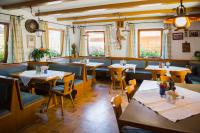 a dining room with tables and chairs and windows at Hotel Gasthof Rose in Oy-Mittelberg