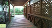 a wooden walkway with awning on a house at New Life Hot Spring Resort in Yuli