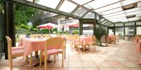 a restaurant with pink tables and chairs in a conservatory at Flackl - Wirt in Reichenau