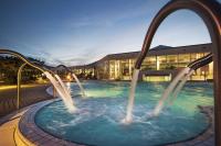 a pool with two water slides in front of a building at Heide Spa Hotel &amp; Resort in Bad Düben