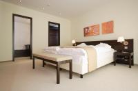 a bedroom with a large white bed and a table at Heide Spa Hotel &amp; Resort in Bad Düben