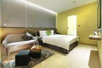a hotel room with a bed and a couch at Beauty Hotels Taipei - Hotel B7 in Taipei