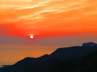 a sunset with the sun setting over the mountains at Formosa Arcadian Villa in Jiufen