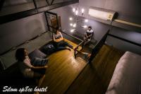 a group of people sitting on a couch in a room at Silom Space Hostel in Bangkok
