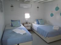 A bed or beds in a room at Anthos House