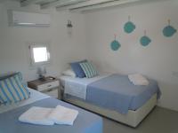 A bed or beds in a room at Anthos House