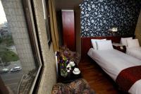 a hotel room with two beds and a window at Gene Long Haiy Att Hotel in Chiayi City