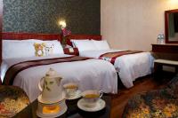 a hotel room with two beds and two cups of coffee at Gene Long Haiy Att Hotel in Chiayi City