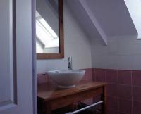 a bathroom with a sink and a mirror at La Grande Mare in Saint-Benoît-des-Ondes