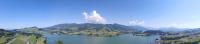 an aerial view of a large lake with mountains at Motel de la Gruyère Restoroute in Avry devant Pont