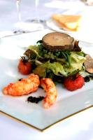 a white plate with a sandwich and lettuce and shrimp at Au Moulin de La Gorce in La Roche-lʼAbeille