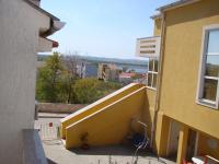a yellow building with a ramp to a balcony at Apartment Tičić in Povljana