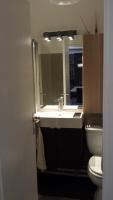 a bathroom with a sink and a toilet and a mirror at Aligre in Paris