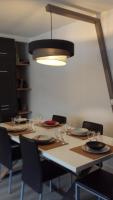 a dining room table with chairs and a light fixture at Aligre in Paris