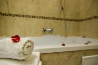 a bathroom with a tub and a towel with a rose on it at Royal San Marco Hotel in Venice