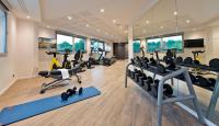 a gym with treadmills and exercise equipment in a room at Golden Tulip Sophia Antipolis - Hotel &amp; Spa in Valbonne