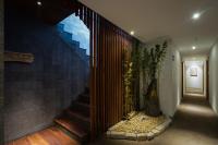 a hallway with a staircase with a plant on the wall at Silverland Yen Hotel in Ho Chi Minh City