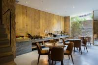 a restaurant with wooden walls and tables and chairs at Silverland Yen Hotel in Ho Chi Minh City