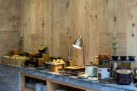 a buffet with food on a counter with wooden walls at Silverland Yen Hotel in Ho Chi Minh City