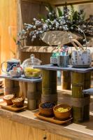 a table with bowls of food on top of wooden shelves at Silverland Yen Hotel in Ho Chi Minh City