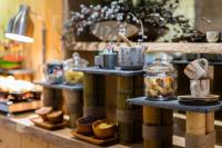 a counter with two shelves with different types of food on it at Silverland Yen Hotel in Ho Chi Minh City