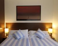 A bed or beds in a room at Pensión Grosen