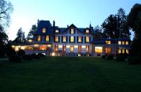 a large house on a lawn at night at Hôtel Villa Navarre in Pau
