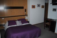 a bedroom with a purple bed and a desk at Hotel Val Joly in Saint-Gervais-les-Bains