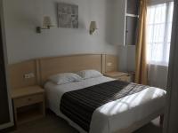 a bedroom with a bed and a window at Hotel De La Mer in La Tranche-sur-Mer