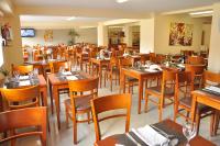 a dining room with wooden tables and chairs at Hotel Riviera in Mar del Plata