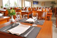 a table in a restaurant with glasses and napkins at Hotel Riviera in Mar del Plata