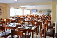 a dining room with wooden tables and chairs at Hotel Riviera in Mar del Plata