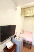 a room with a flat screen tv on the wall at Beauty Home Homestay in Hualien City