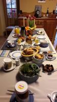 a table topped with plates and bowls of food at La Grande Mare in Saint-Benoît-des-Ondes