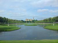 a view of a lake with a building in the background at Pension Karina Schwerin in Schwerin