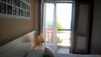 a bedroom with a bed and a window with a view at Pousada DiMari in Boicucanga