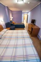 Posteľ alebo postele v izbe v ubytovaní Hotel El Roble