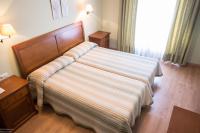 Posteľ alebo postele v izbe v ubytovaní Hotel El Roble