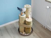 a cake with a seagull sitting on top of wooden logs at Fischerhaus Bremerhaven in Bremerhaven