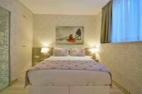 A bed or beds in a room at Adamel City Hotel