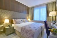 A bed or beds in a room at Adamel City Hotel