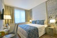 A bed or beds in a room at Adamel City Hotel