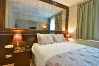 A bed or beds in a room at Adamel City Hotel