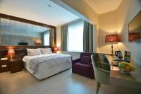 A bed or beds in a room at Adamel City Hotel