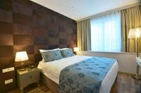 A bed or beds in a room at Adamel City Hotel