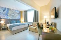 A bed or beds in a room at Adamel City Hotel