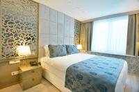 A bed or beds in a room at Adamel City Hotel