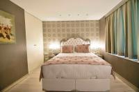 A bed or beds in a room at Adamel City Hotel