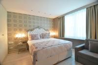 A bed or beds in a room at Adamel City Hotel