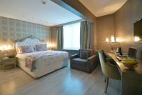 A bed or beds in a room at Adamel City Hotel